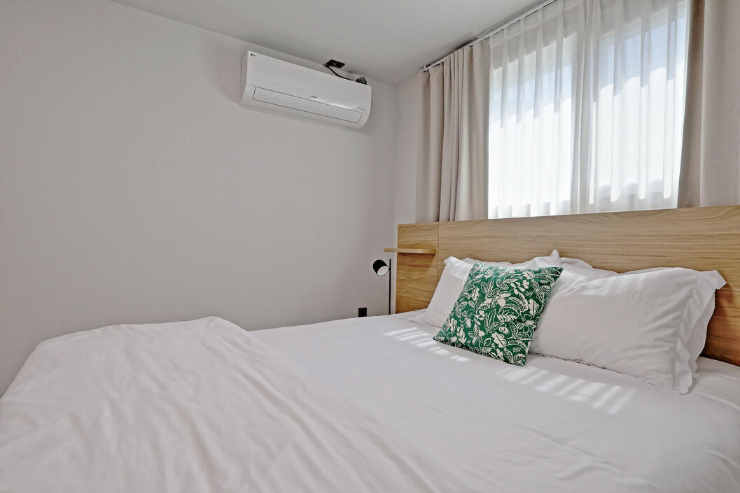 Air conditioner and blackout curtains.