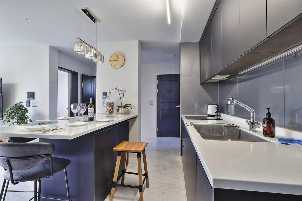 View of the kitchen and dining area, facing the entrance of the home.